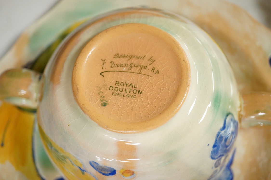 A collection of Doulton Brangwynware to include an oval dish, wall plate and two coffee cans and saucers, largest 32cm in diameter